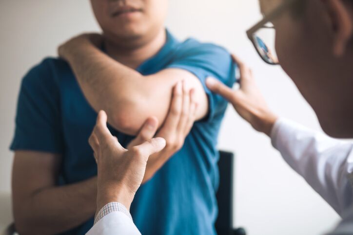 Physical therapists are checking patients elbows at the clinic office room. houston tennis elbow care